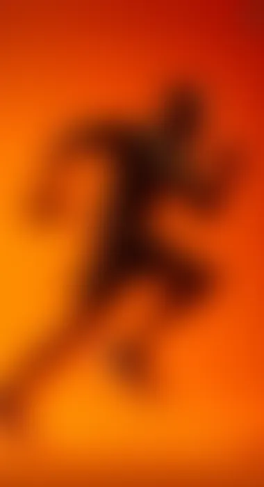 Blurred orange silhouette of a runner in motion